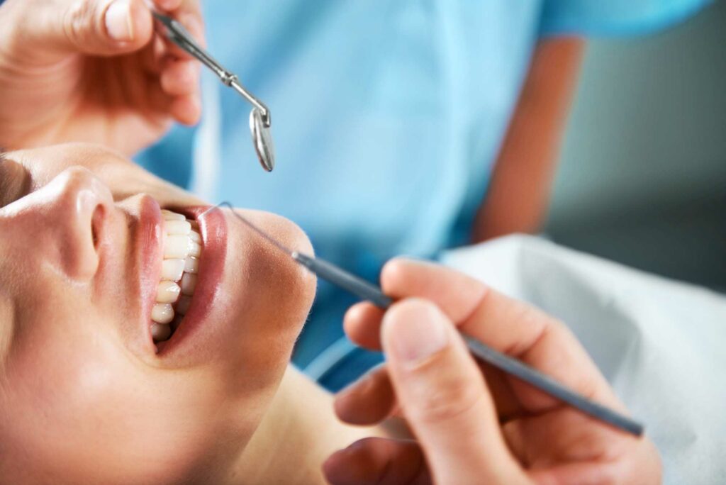 Woman getting a routine dental cleaning.